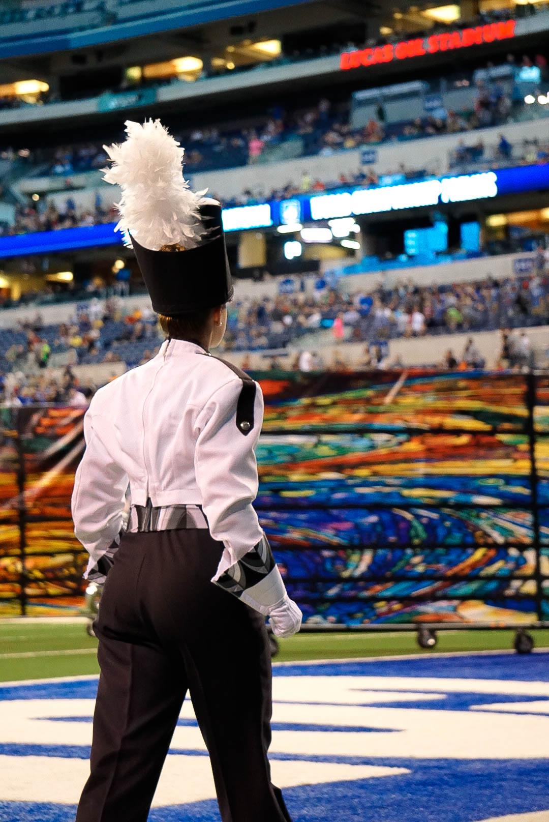 A drum major marching on to the field prior to their show.
