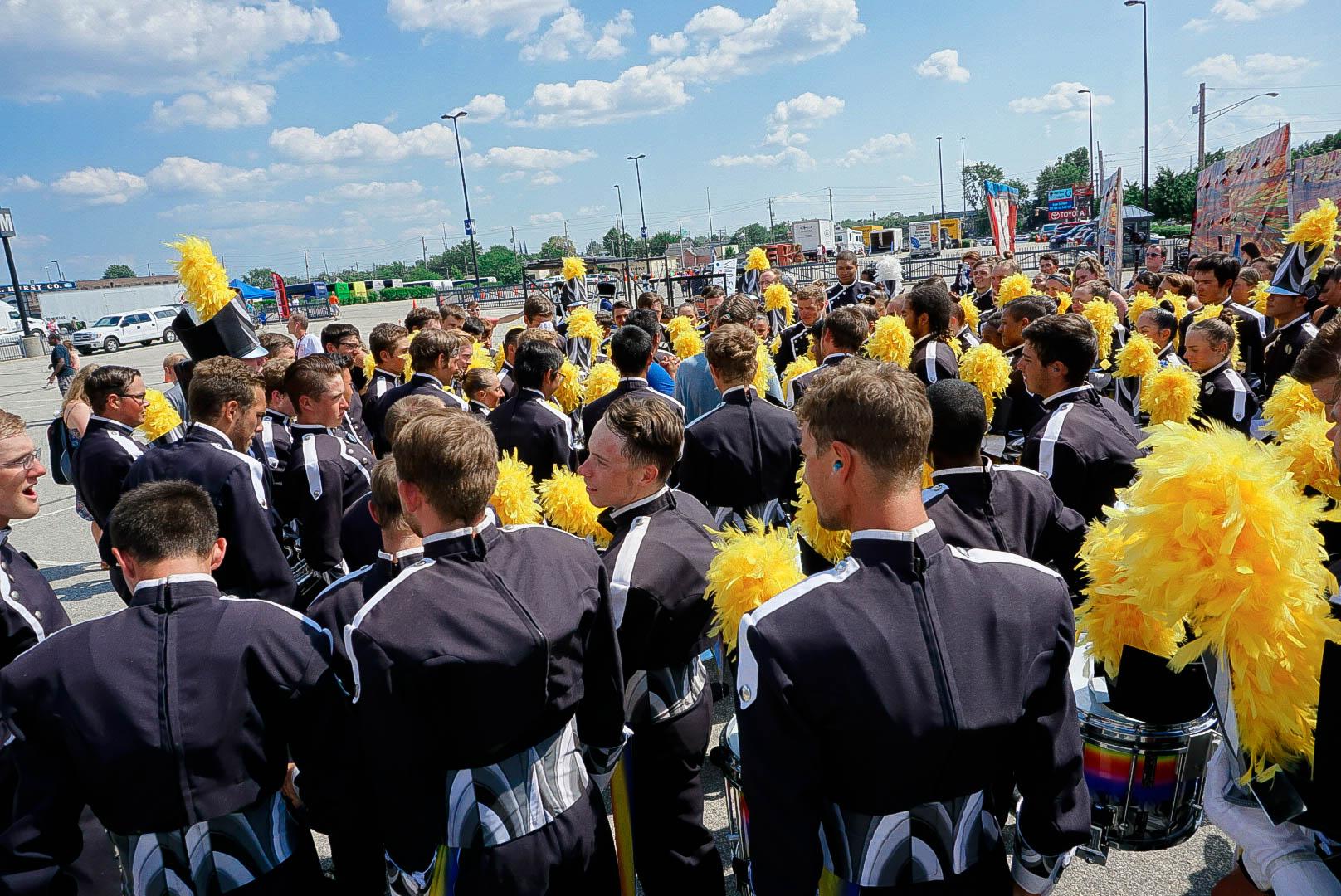 A drum corps following their performance outside the stadium.